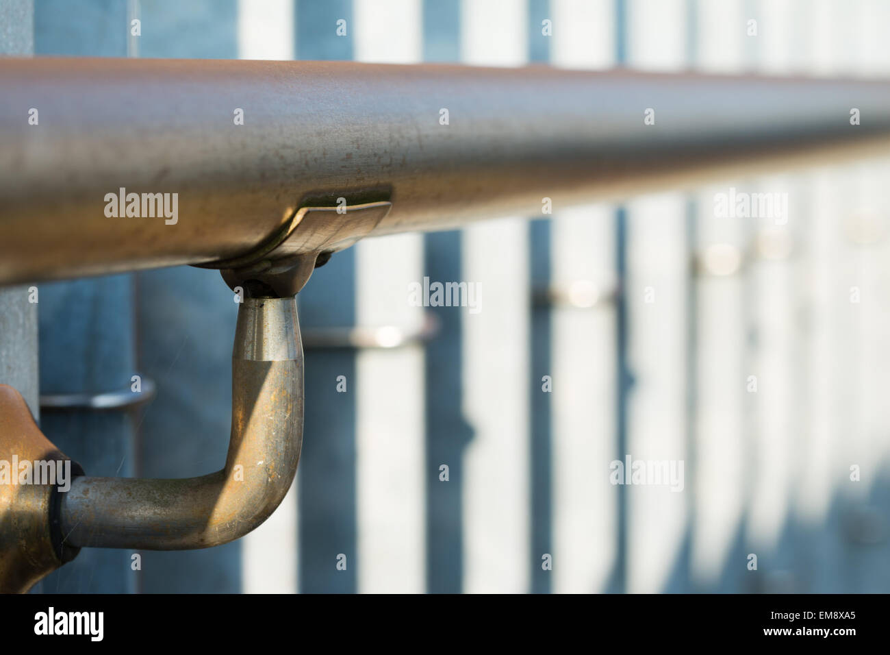 A metal railing on a metal fence with a shallow focus. Stock Photo