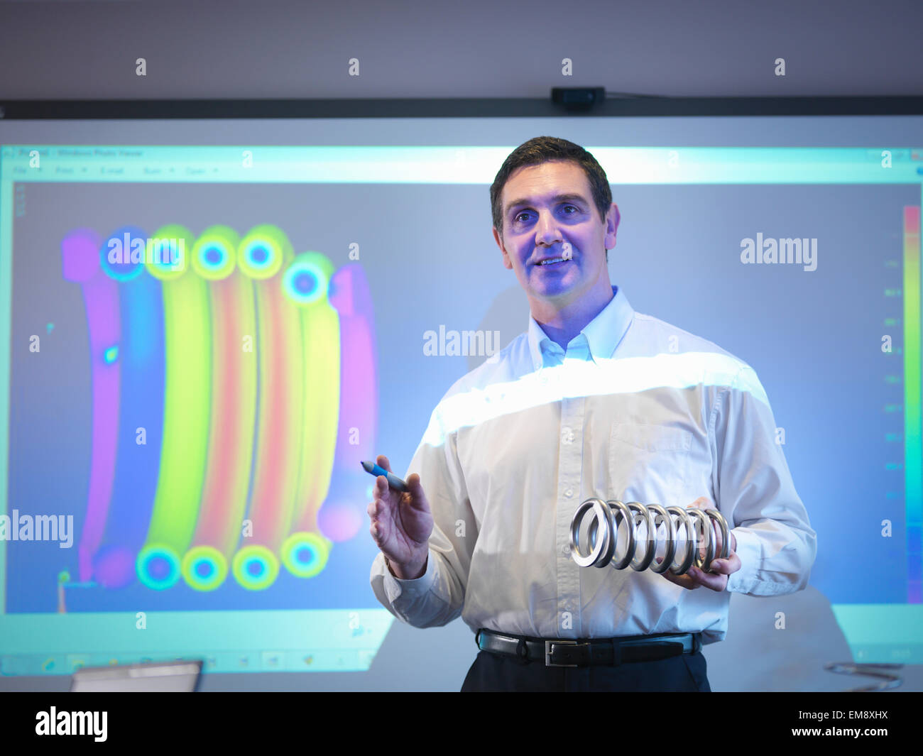 Engineer making business presentation in front of screen Stock Photo