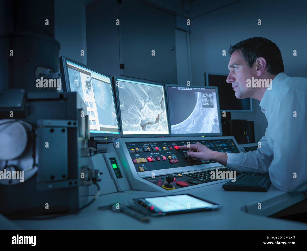 Metallurgist working with electron microscope in automotive test facility Stock Photo
