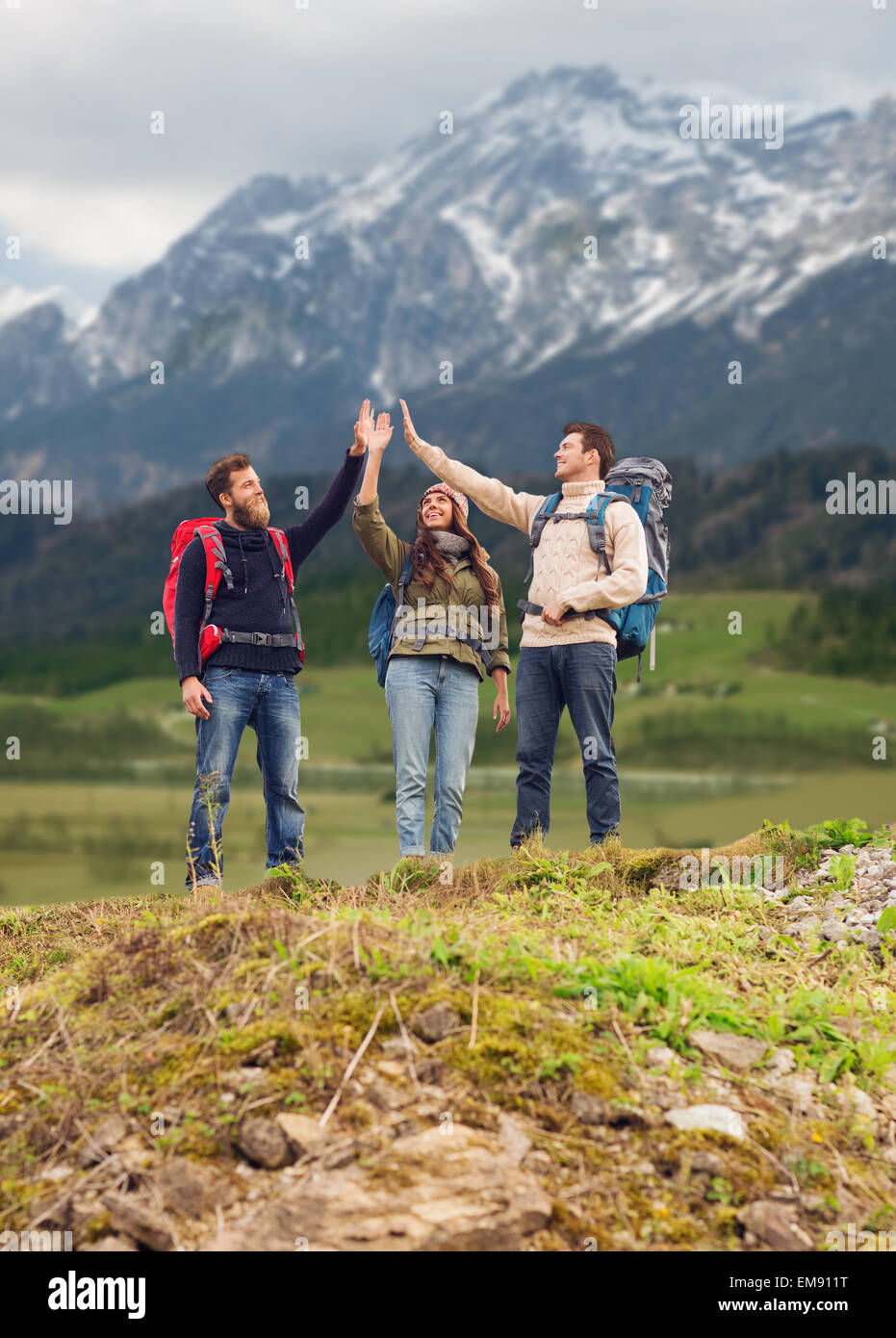 group of smiling friends with backpacks hiking Stock Photo - Alamy