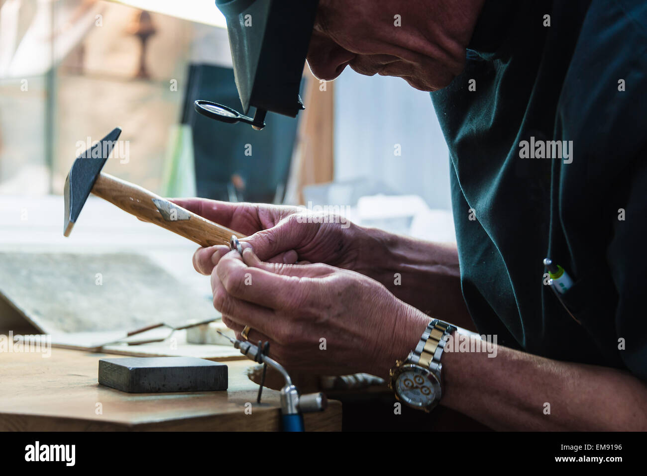 Jewellery craftsman examining platinum ring Stock Photo Alamy