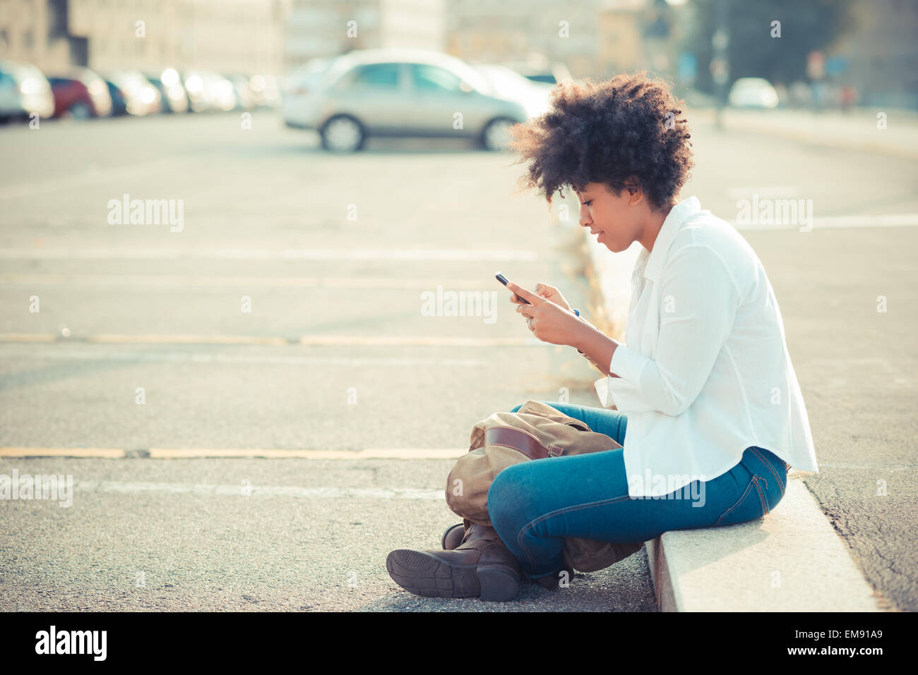 Black woman texting on city hi-res stock photography and images - Alamy
