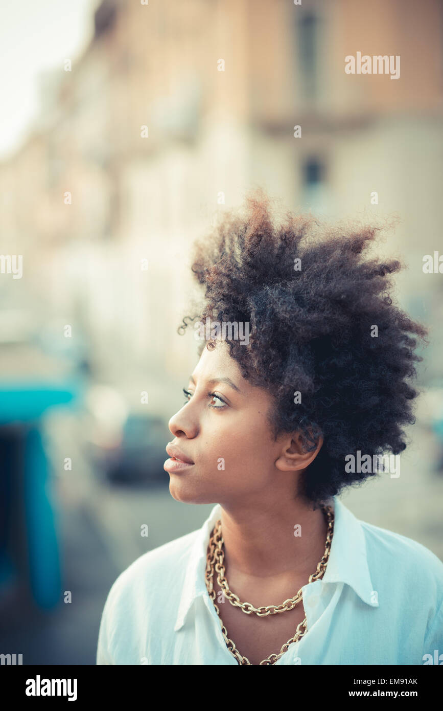 Portrait of beautiful young woman gazing in city Stock Photo