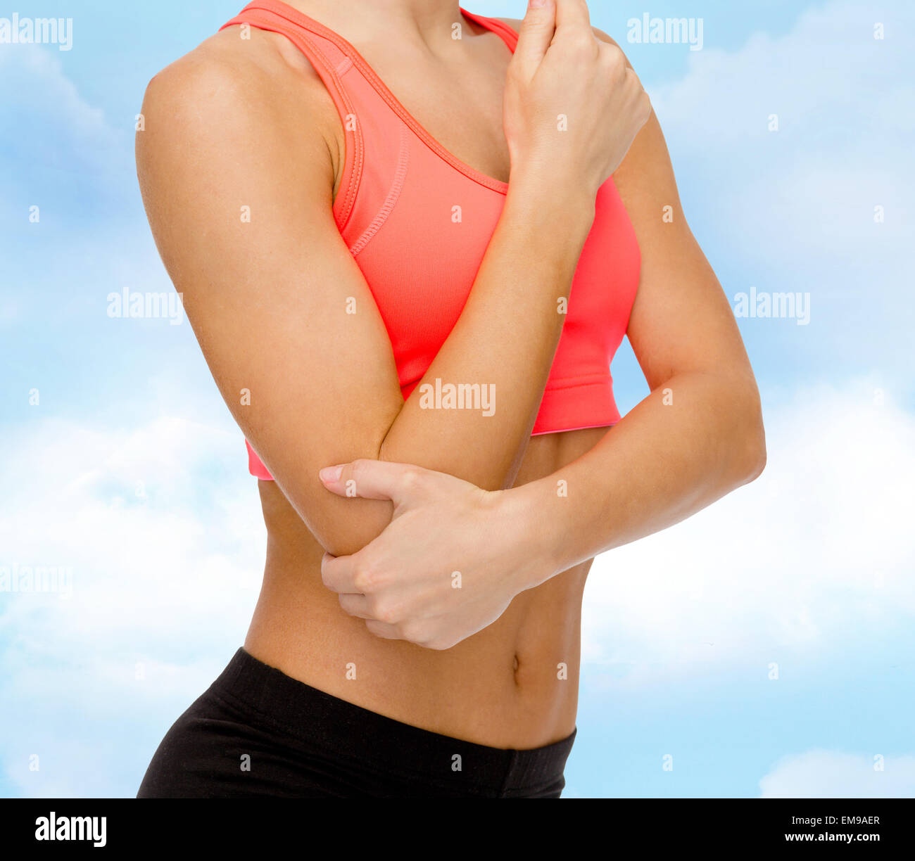 sporty woman with pain in elbow Stock Photo
