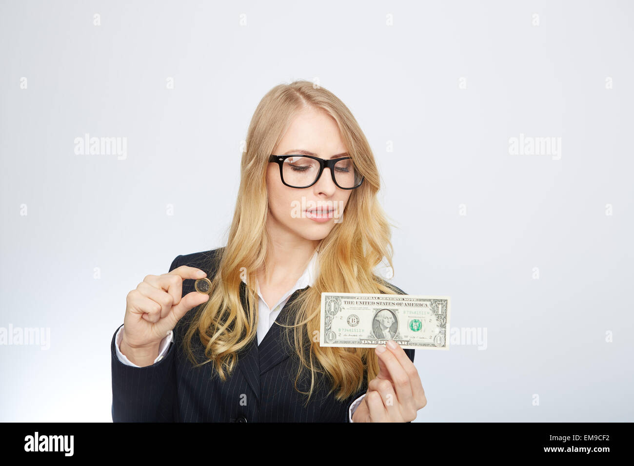 Attractive business woman.  Holding a one dollar and euro. Stock Photo