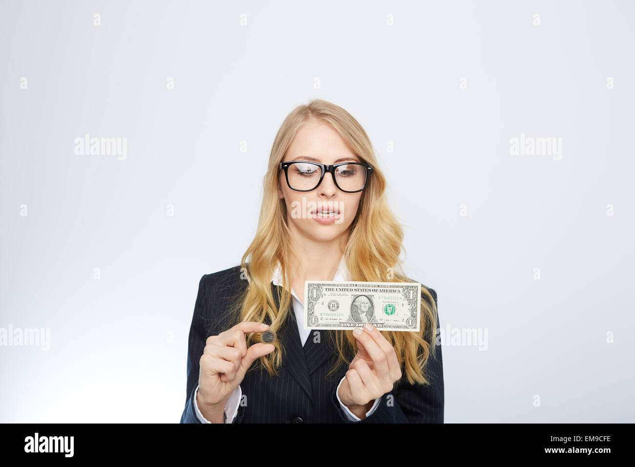 Attractive business woman.  Holding a one dollar and euro. Stock Photo