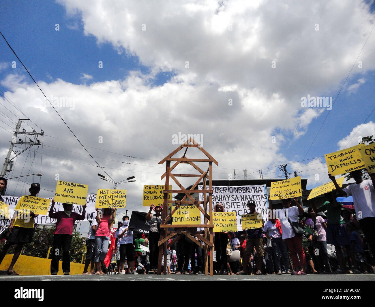 Filipino activists raise placards calling for decent housing around a makeshift home, during a rally in Mendiola Bridge, to protest the demolition of homes of informal settlers. Informal settler groups are demanding Philippine President Benigno Aquino III to issue an Executive Order favoring onsite housing for informal settlers. They also demand President Aquino to halt the planned North Bay Boulevard Project in Navotas City that would reclaim around 5,000 hectares of foreshore lands, in which informal settler groups allege would displace 20,000 families of informal settlers and fishers. (Phot Stock Photo