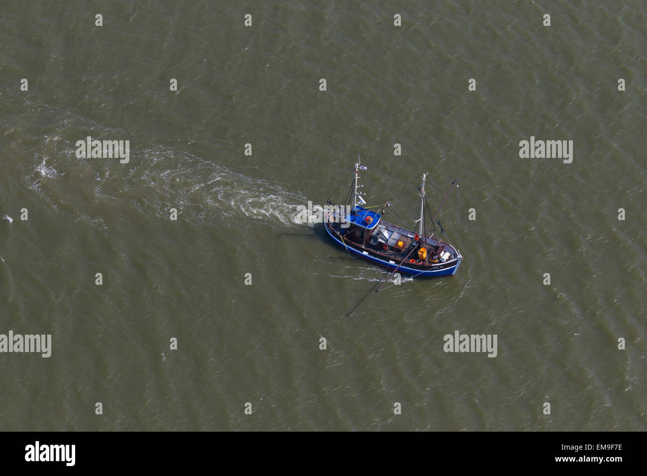 Bird's eye view of blue shrimp trawler boat fishing for shrimps at sea Stock Photo