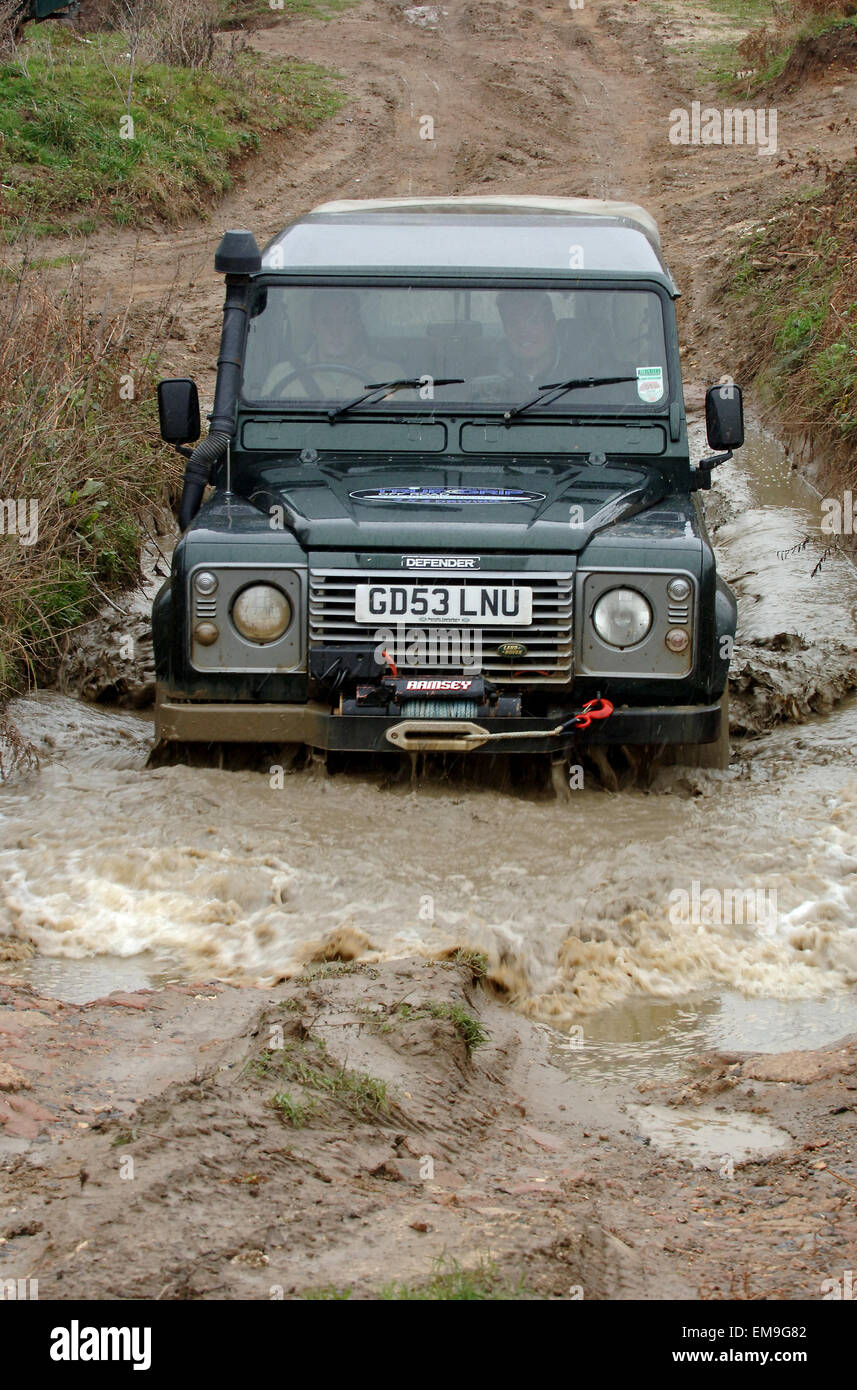 Land Rover Defender driving off road, wading in deep water Stock Photo