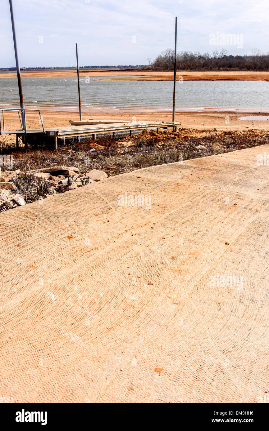 A boat dock and ramp rests high and dry away from waters' edge  at the drought stricken Lake Hefner, a municipal water supply of Oklahoma City,OK, USA Stock Photo