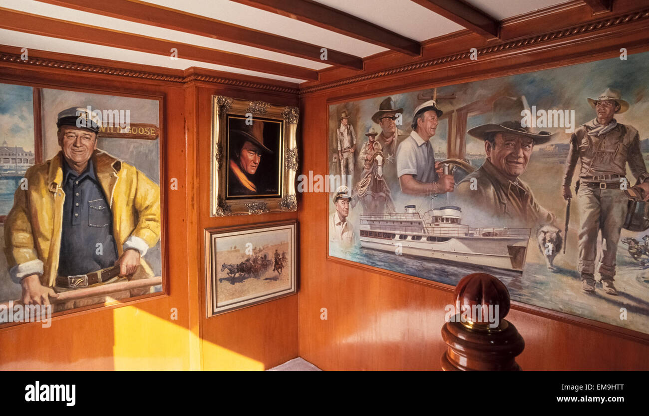 Famous Hollywood movie actor John Wayne is the star of the artwork that is aboard his luxury yacht, the Wild Goose, which currently is a for-hire party boat based in his former hometown of Newport Beach, California, USA. The paintings are by his third wife, Pilar Wayne, and Orange County artist Frank Tauriello. The Duke, as Wayne was nicknamed, spent more than a million dollars converting a U.S. Navy minesweeper from World War II into his 136-foot (41.5-meter) pleasure craft in 1962. Wayne and his extended family used the impressive vessel for 17 years until his death at the age of 72. Stock Photo