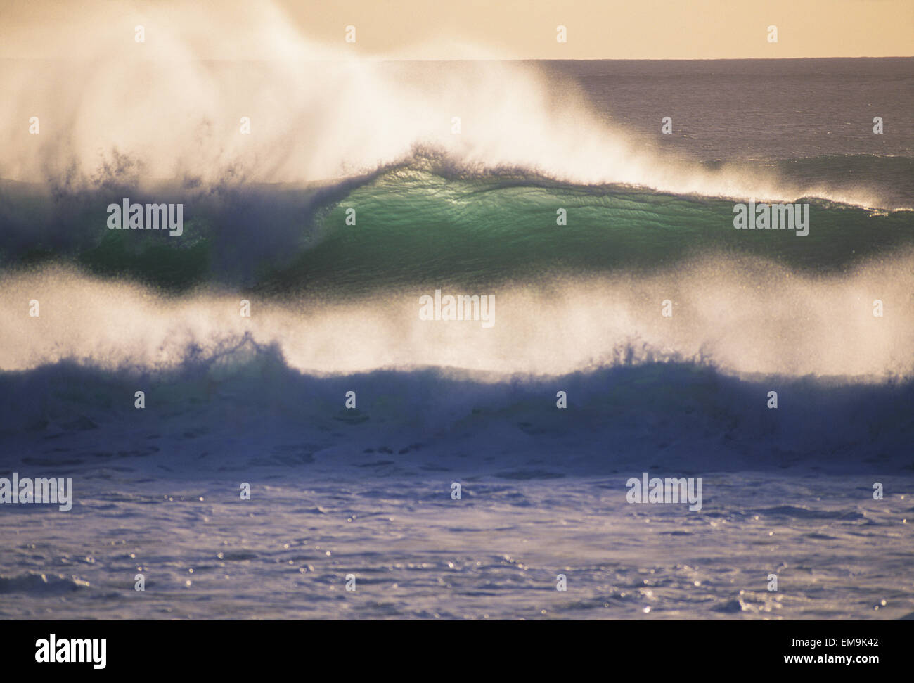 Glassy Wave Curling Over At Sunset With White Wash, View From Shore Stock Photo