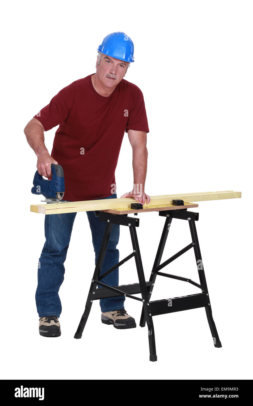 Carpenter cutting piece of wood Stock Photo - Alamy