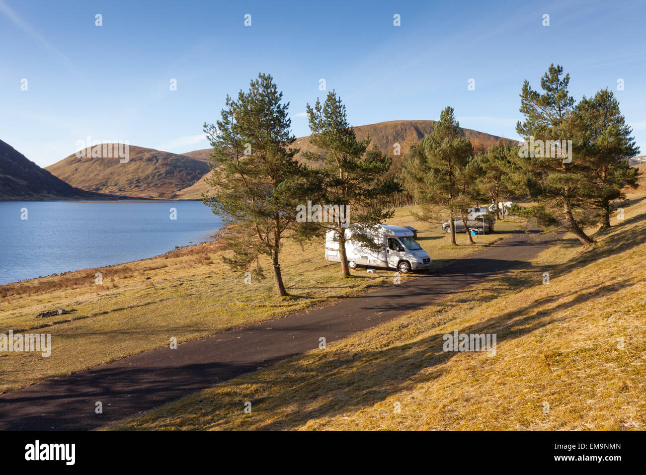 Campervans on a roadside campsite, on St Mary's Loch, nr Moffat