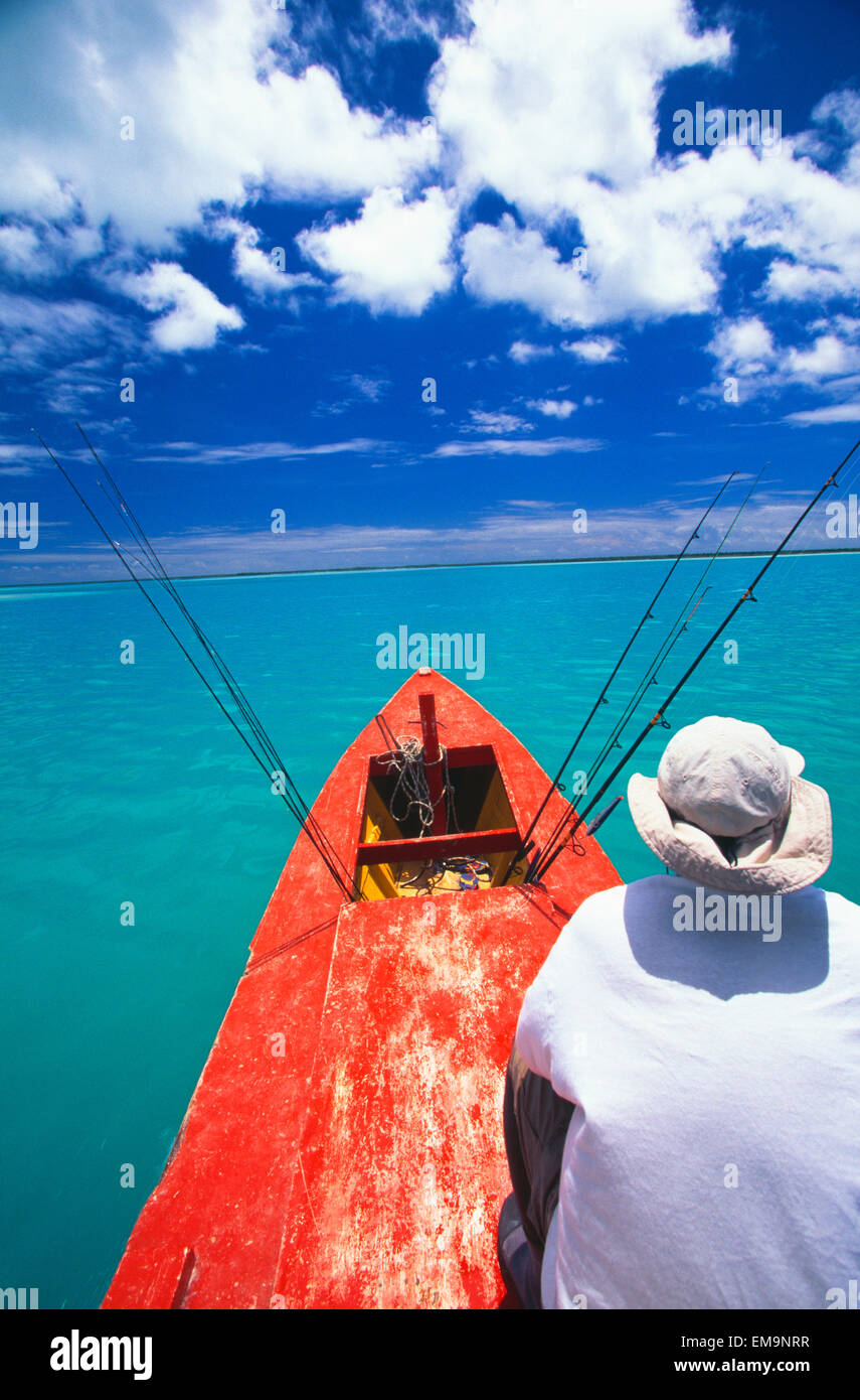 Kiribati, Kiritimati (Christmas Island), Bone Fishing From A Red Boat, Man Sits In Front. Stock Photo