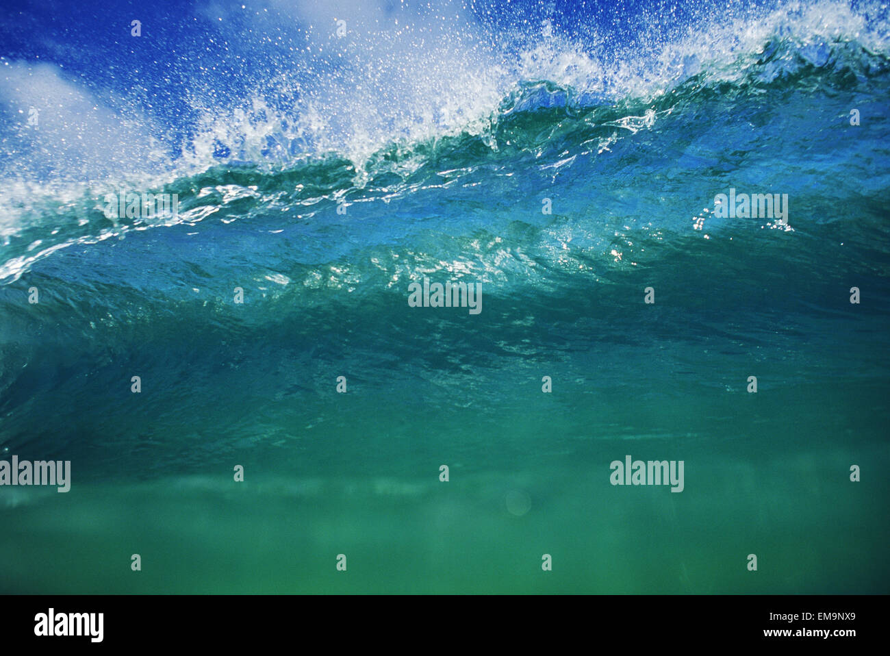 Hawaii, Green Wave At It's Peak With White Wash, Blue Sky Stock Photo