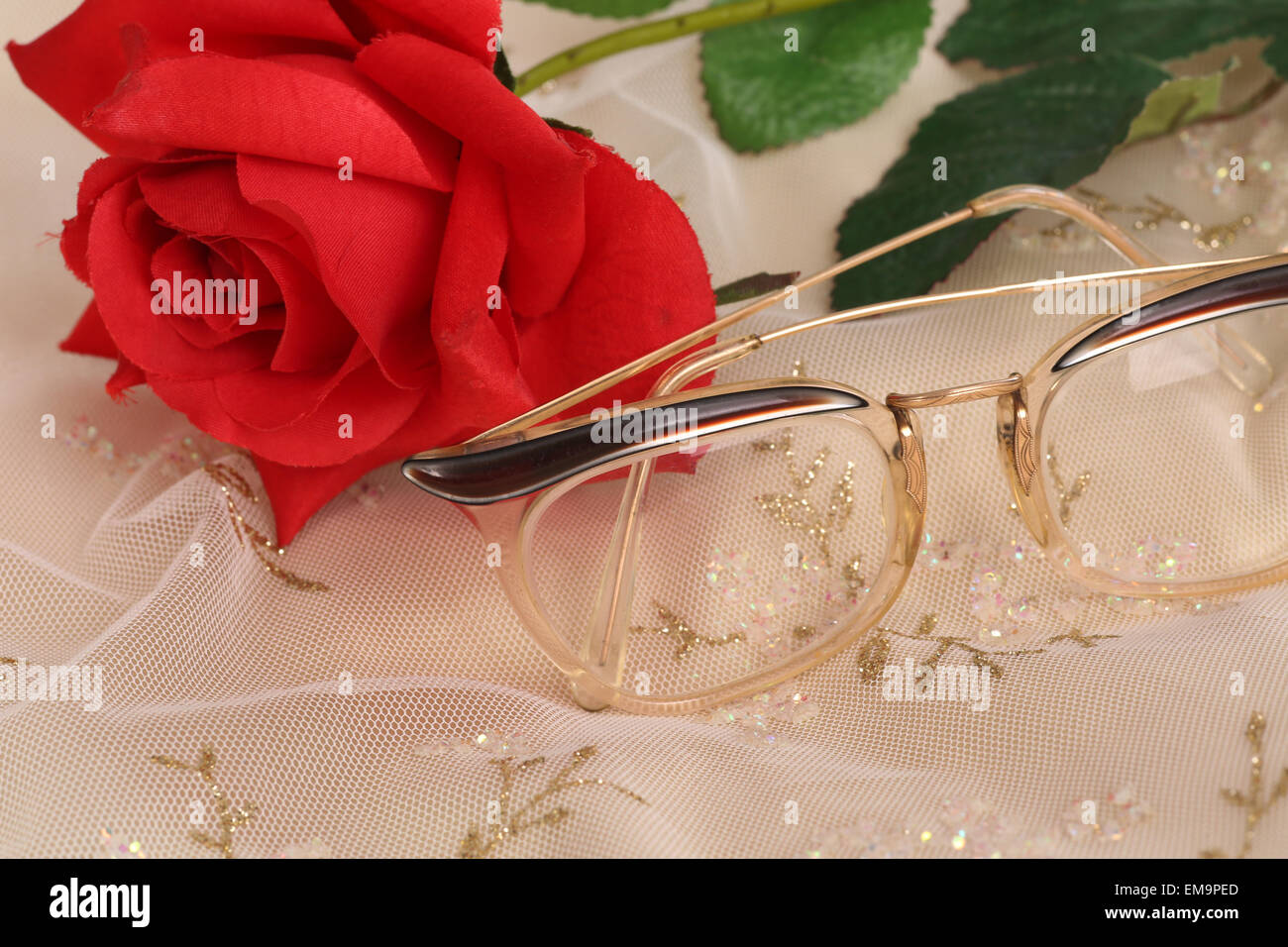 Red rose and glasses on a pretty background Stock Photo Alamy
