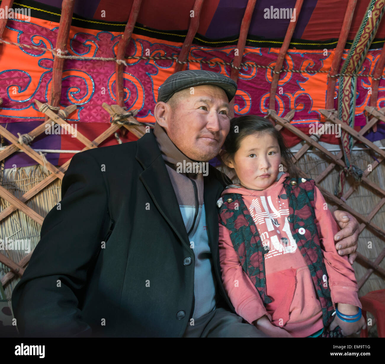 Kazakh father and daughter in a ger, Western Mongolia Stock Photo
