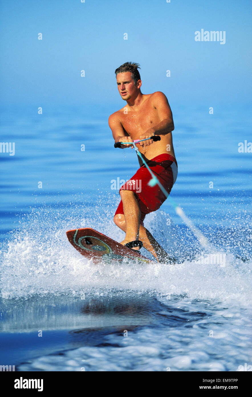 Hawaii, Maui, Kaanapali, Man Wakeboarding Holds On To Tow Rope Stock Photo Alamy
