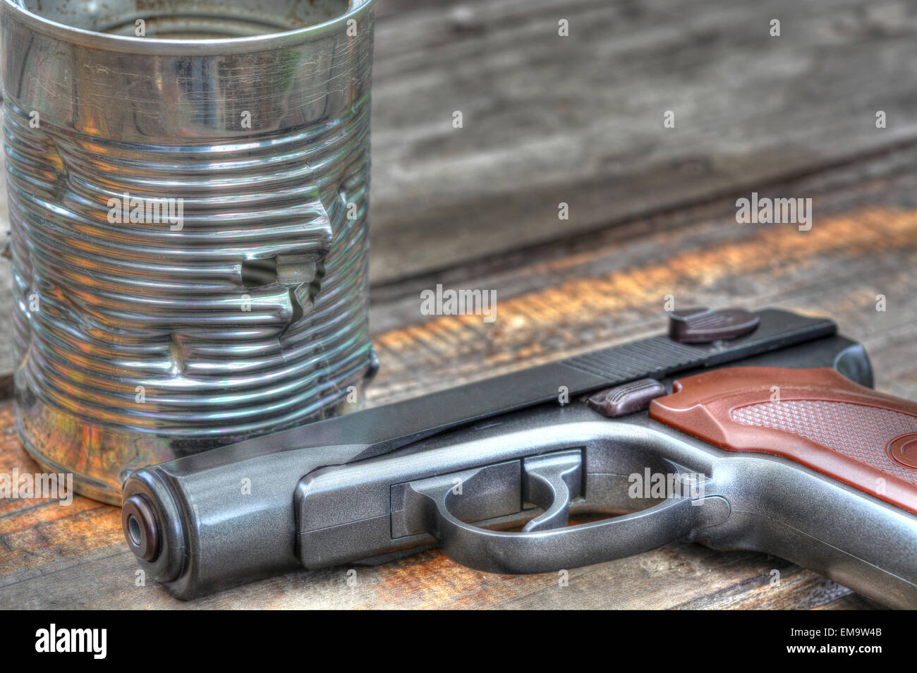 Tin can full of holes from a BB gun fire Stock Photo