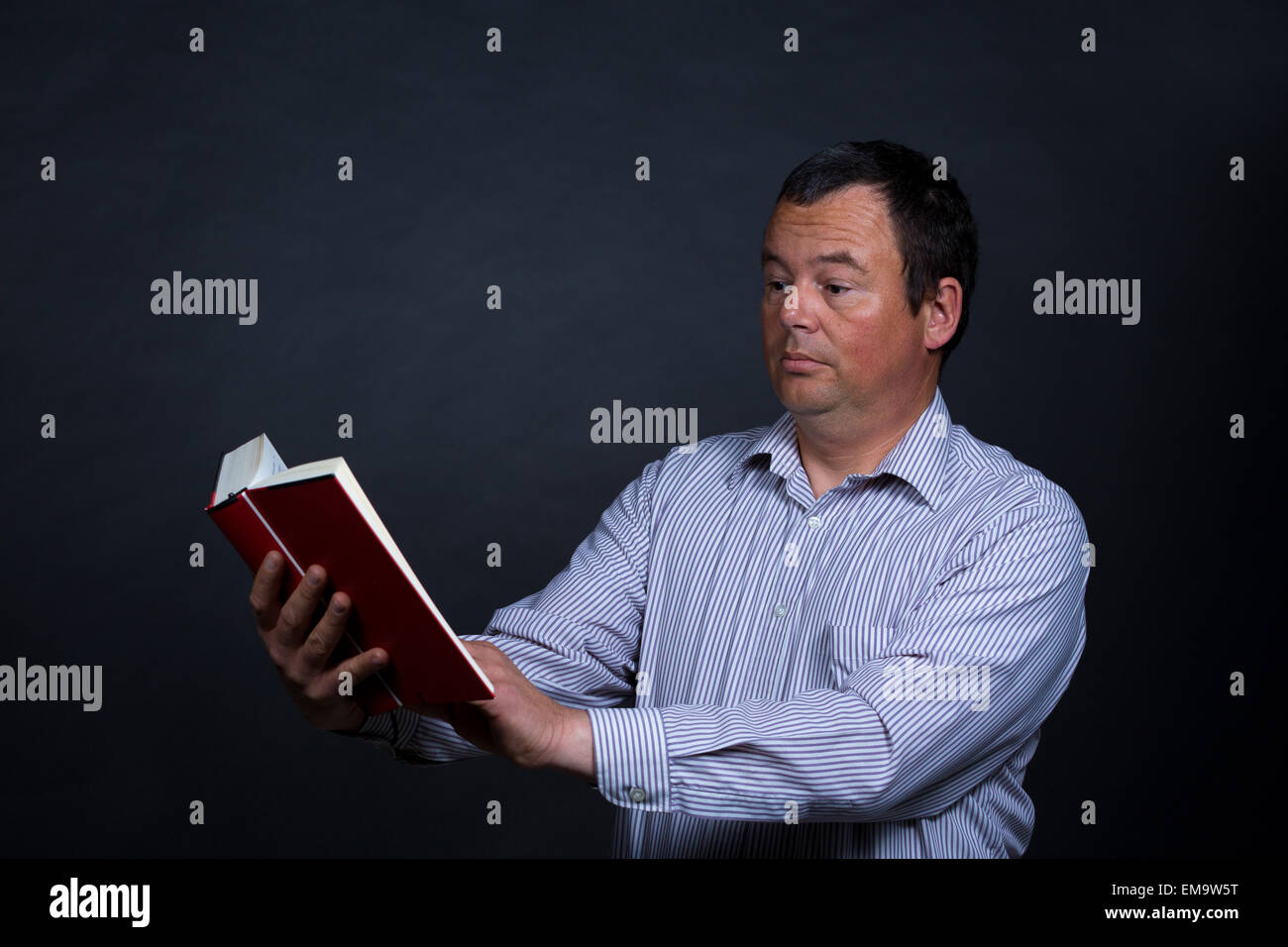 Man finding it increasingly difficult to read without glasses Stock Photo Alamy