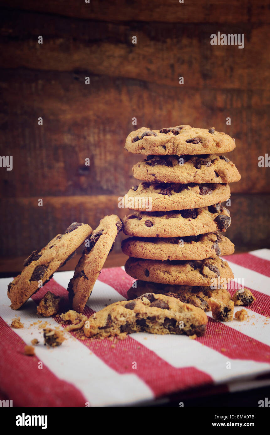 Stack of chocolate chip cookies on red and white stripe napkin against