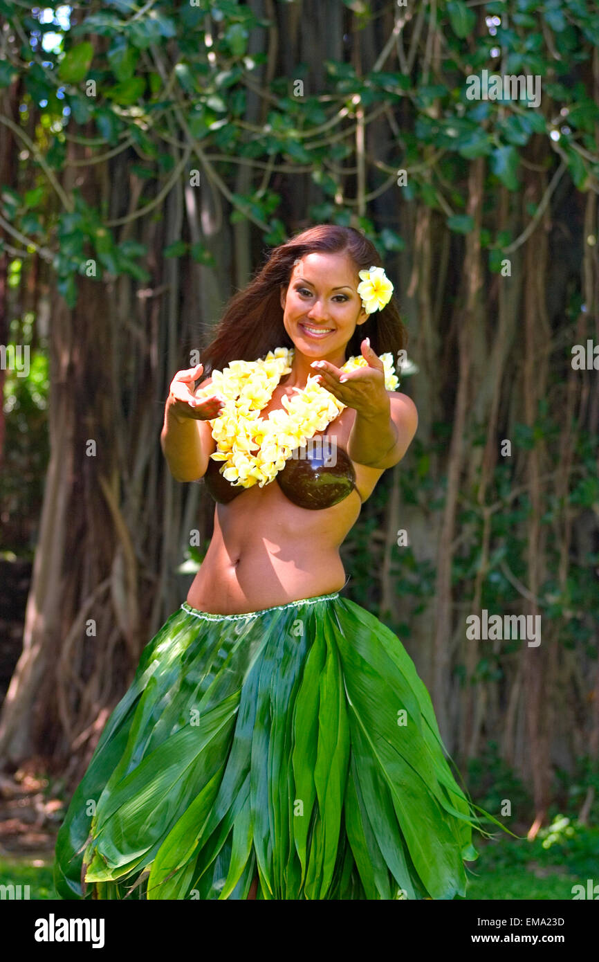 Female Hawaiian Hula Dancer Wearing Coconut Bikini, Yellow Lei, And Leaf  Skirt Stock Photo - Alamy