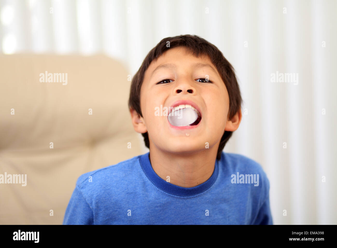 Young boy eating ice cube Stock Photo