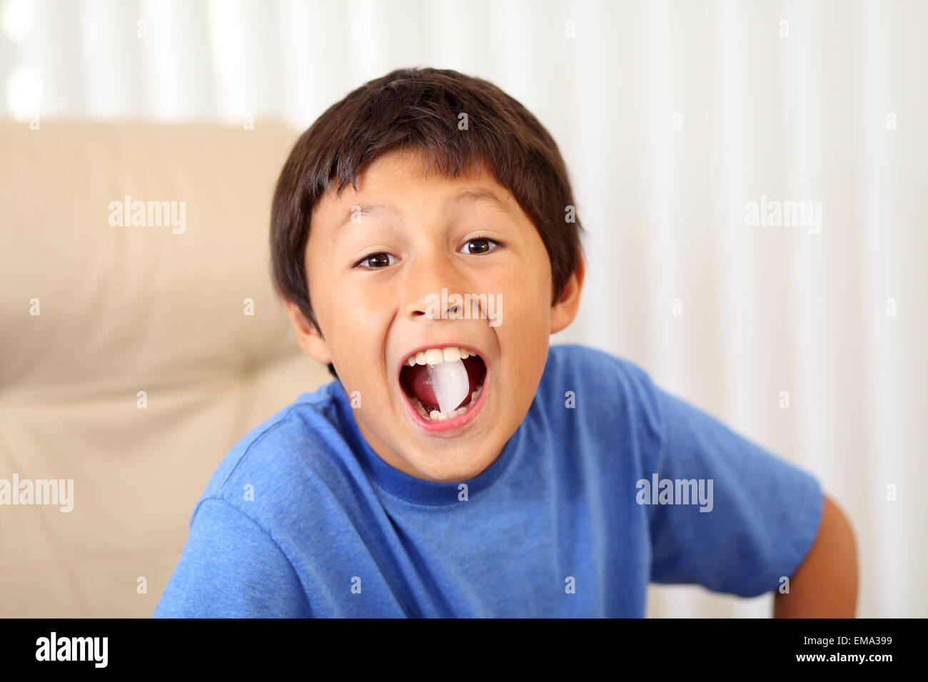 Young boy eating ice cube Stock Photo