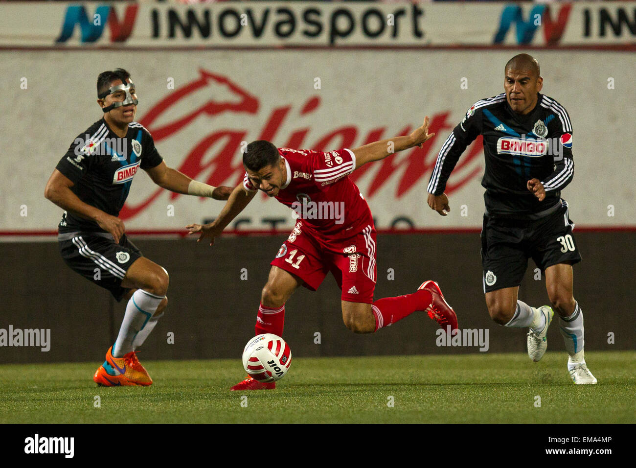 Tijuana, Mexico. 17th Apr, 2015. Xolos' Henry Martin (C) vies for the ball with Chivas' Carlos Salcido (R) and Carlos Salcedo during the match at Day 14 of the 2015 Closing Tournament of the MX League, in the Caliente Stadium in Tijuana city, northwest of Mexico, April 17, 2015. © Guillermo Arias/Xinhua/Alamy Live News Stock Photo