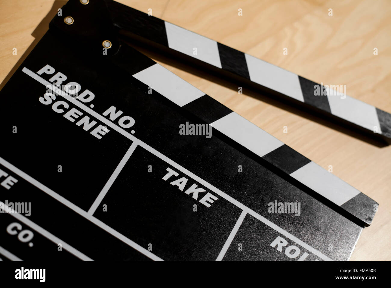 Color picture of a cinema clap on a wooden table. Stock Photo