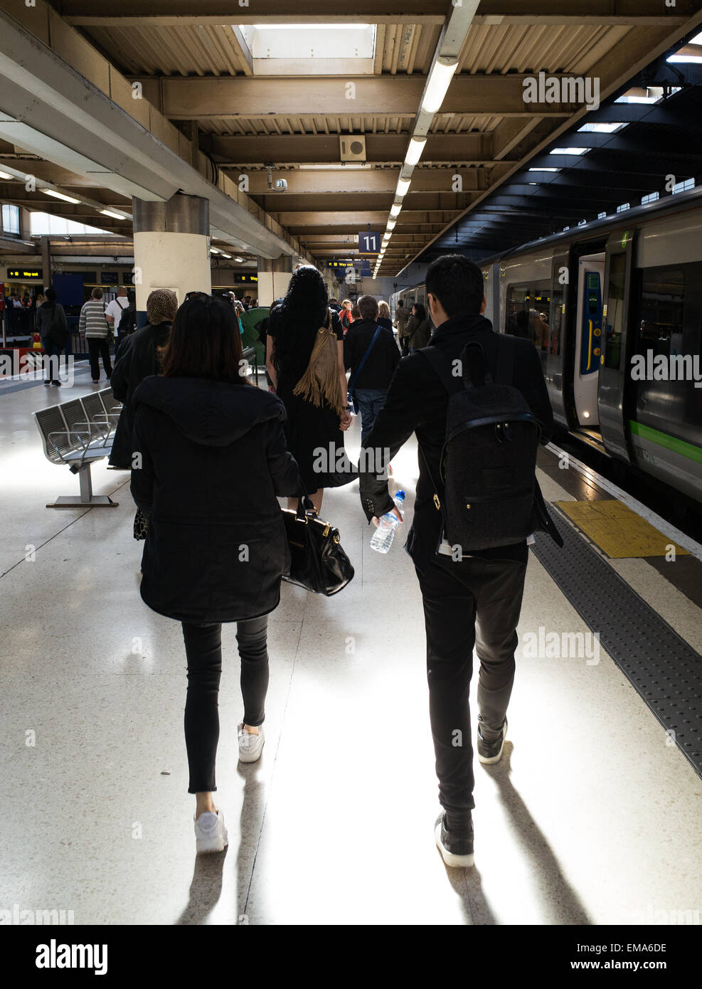 Passengers walk along a platform at Euston station, London, after alighting from a train. Stock Photo
