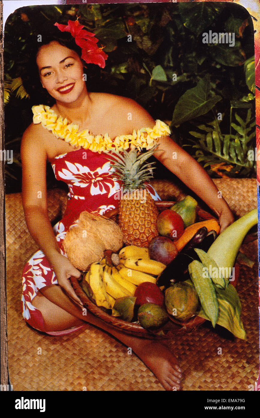 C.1955 Pretty Hawaiian Woman Holding Basket Of Fruit, Sits On Lauhala Mat, Smiling C1515 Stock Photo