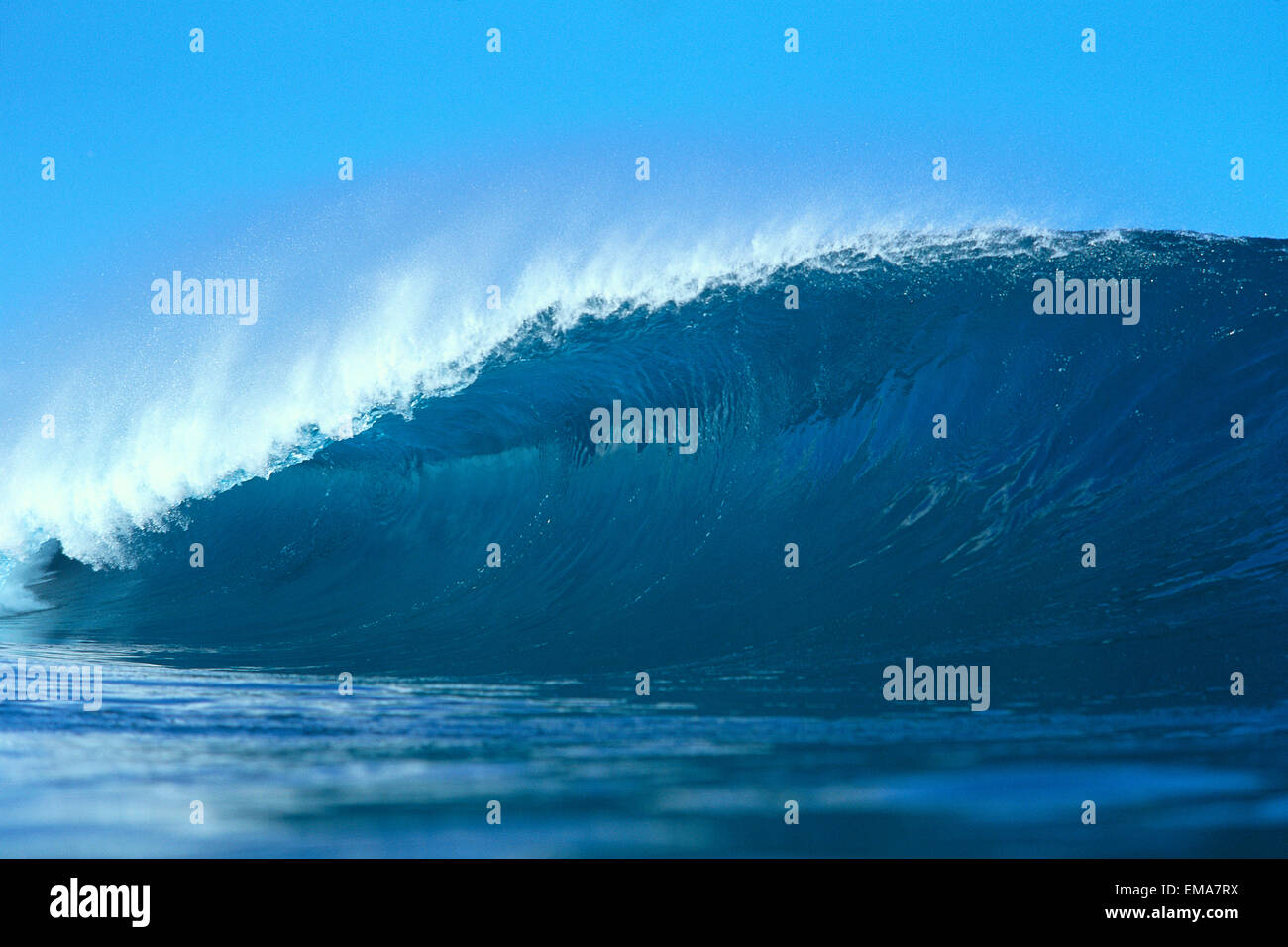 View Of Long, Large, Blue Wave, Curled At One End, Blue Sky In Background C1753 Stock Photo