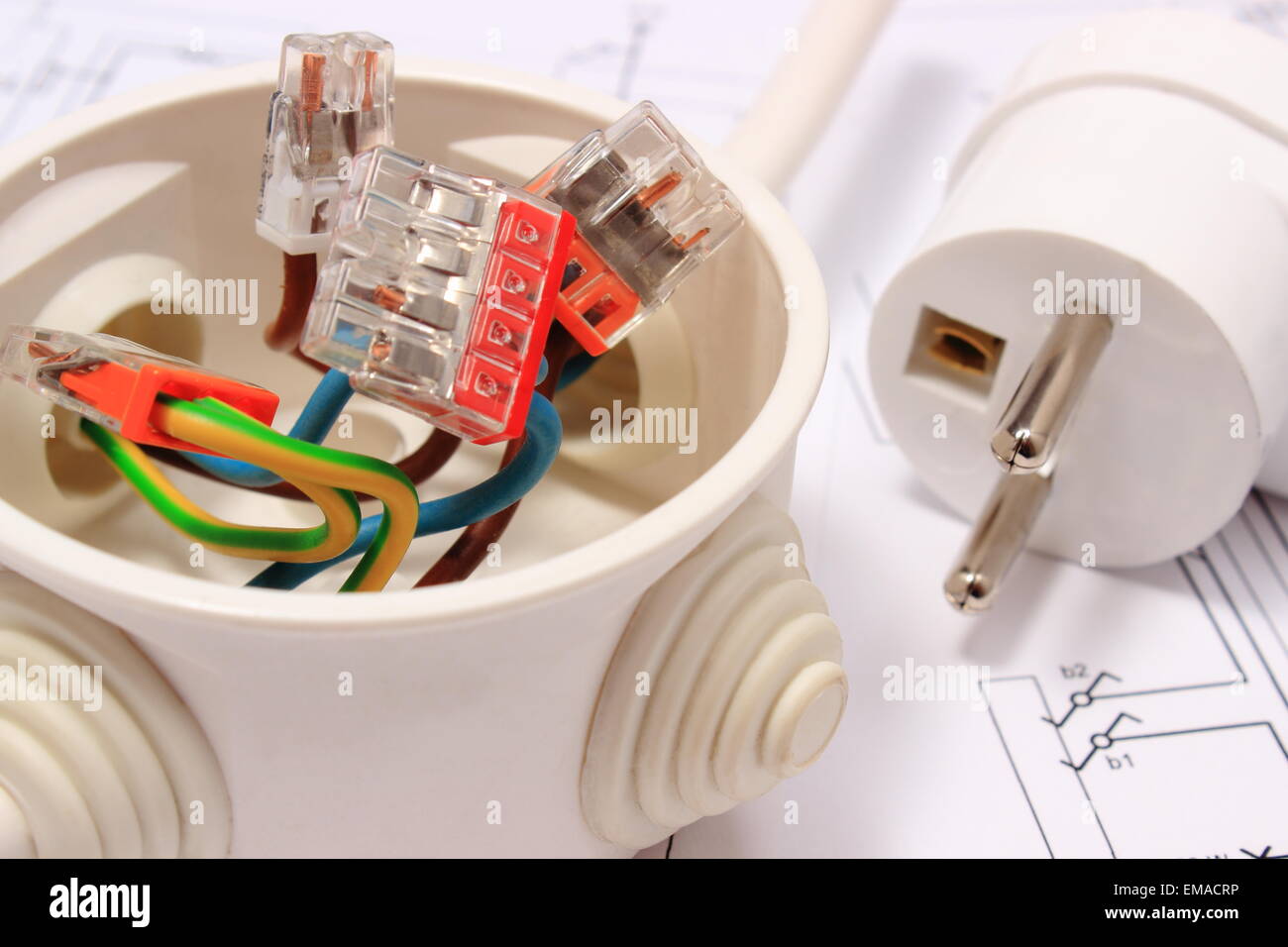 Copper wire connections in electrical box and electric plug lying on