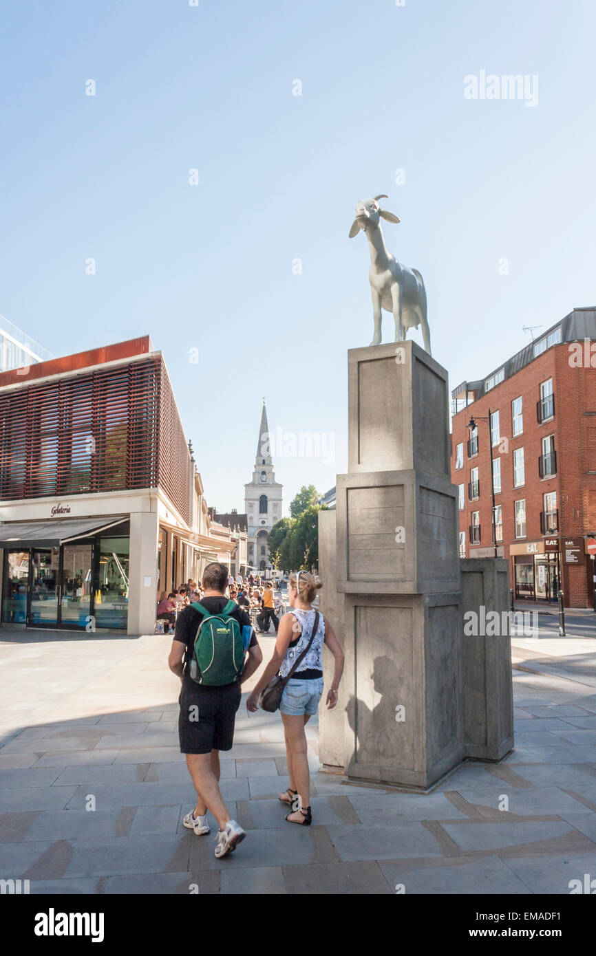 London tourists walk past 'I Goat' by Kenny Hunter, the winning design of the Spitalfields Sculpture Prize 2010. Stock Photo