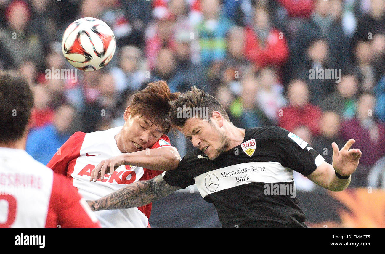 Augsburg, Germany. 18th Apr, 2015. Augsburg's Jeong-Ho Hong (l) and Stuttgart's Daniel Ginczek compete for the ball during the German Bundesliga soccer match between FC Augsburg and VfB Stuttgart at the SGL - Arena in Augsburg, Germany, 18 April 2015. PHOTO: STEFAN PUCHNER/dpa (EMBARGO CONDITIONS - ATTENTION: Due to the accreditation guidelines, the DFL only permits the publication and utilisation of up to 15 pictures per match on the internet and in online media during the match.) © dpa/Alamy Live News Stock Photo