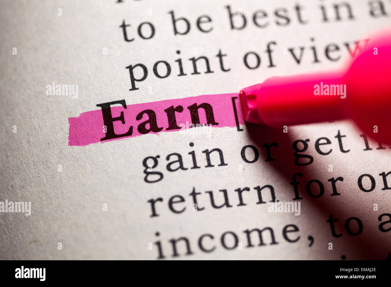 Fake Dictionary, Dictionary definition of the word earn. Stock Photo