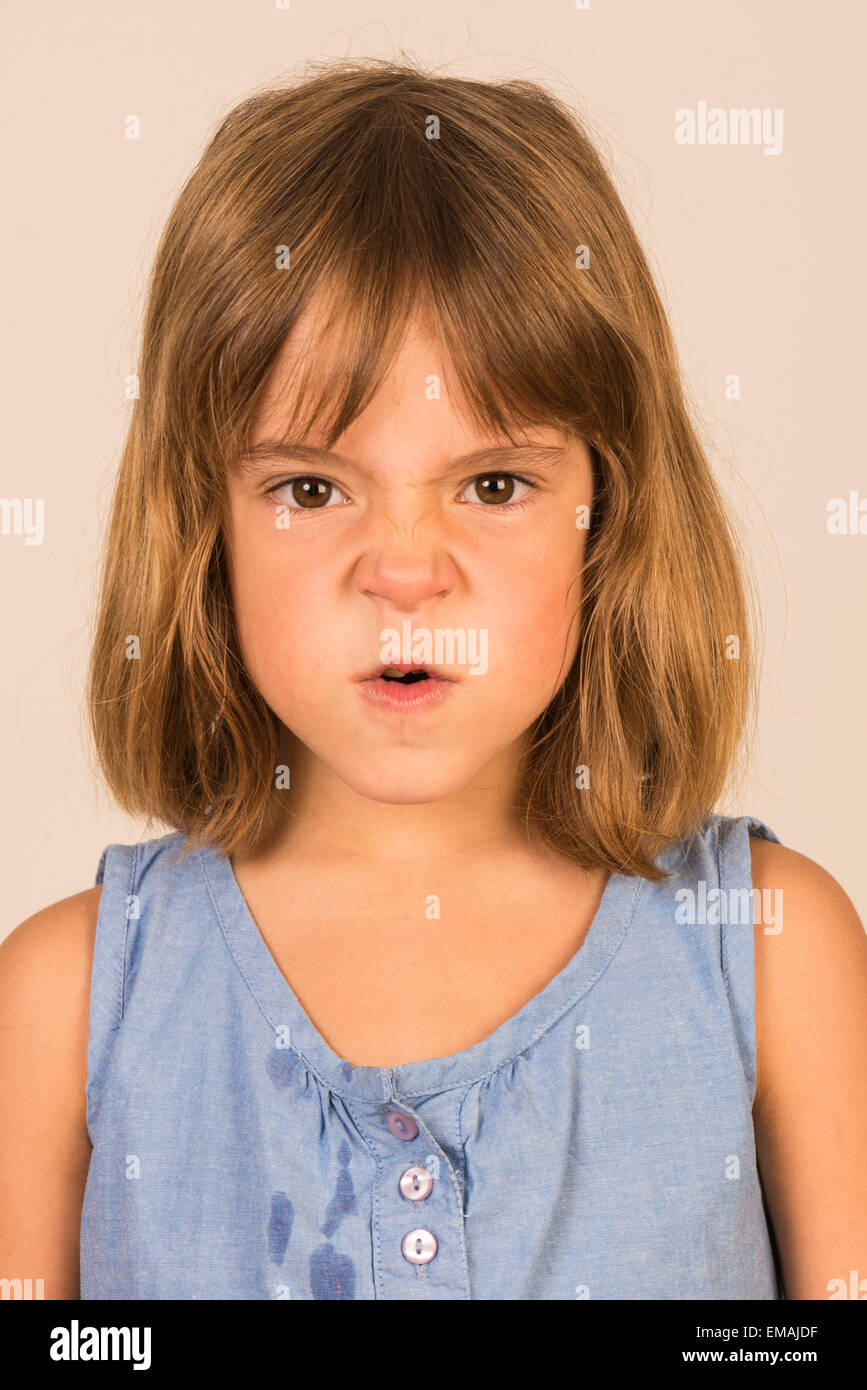 angry little girl looking at camera Stock Photo - Alamy