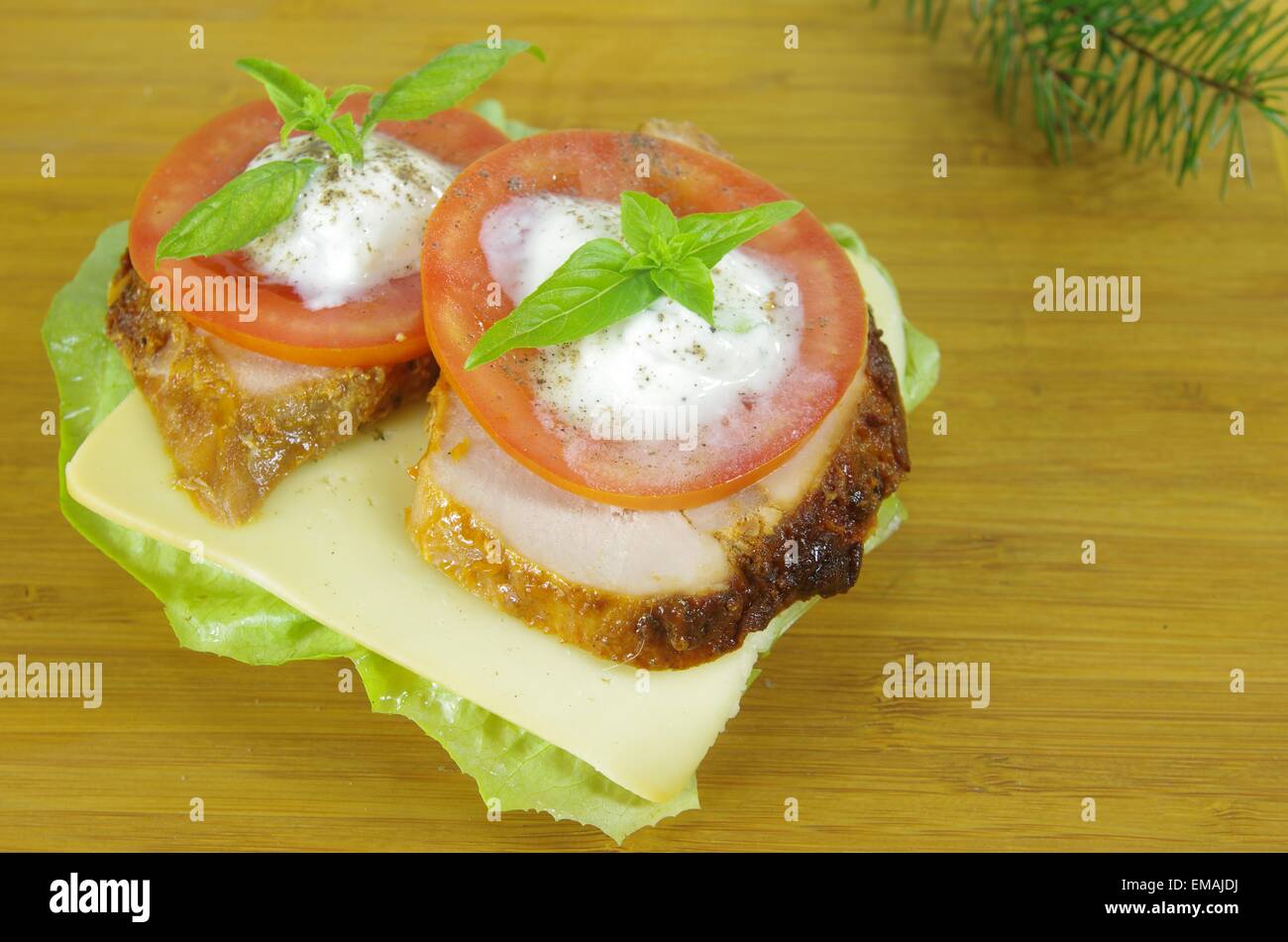 appetizing sandwich with meat and tomato on board Stock Photo