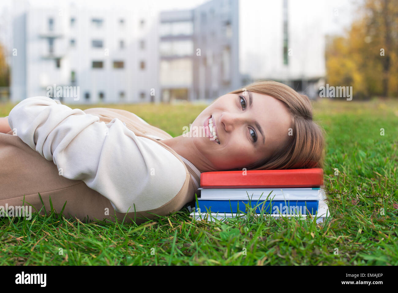 Student lying on green grass and books. On the sunset Stock Photo - Alamy