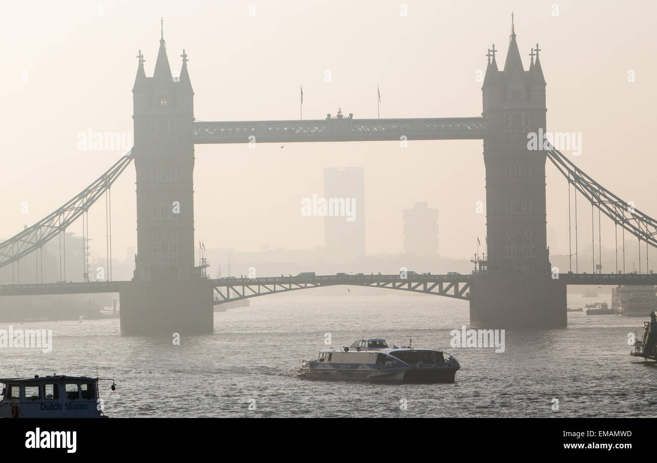 Heavy smog lies in the morning air with an easterly view of Tower Bridge in London showing pollution from carbon emissions Stock Photo