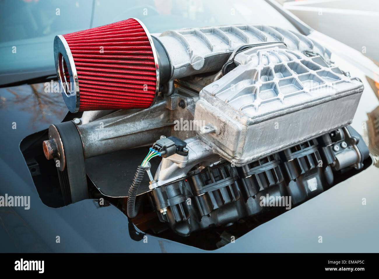 Supercharger, air compressor that increases the pressure or density of air supplied to an internal combustion car engine, closeu Stock Photo