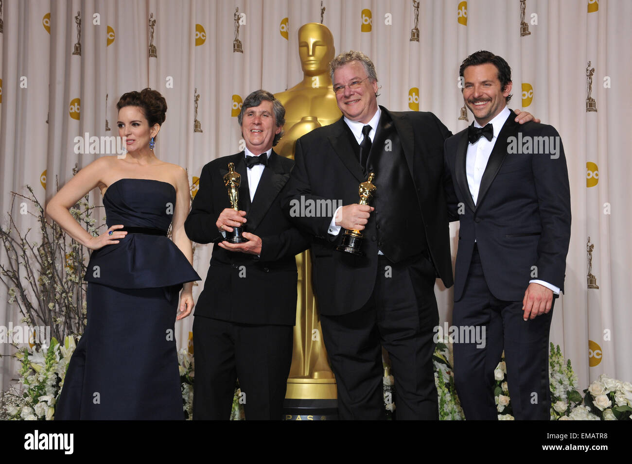 LOS ANGELES, CA - FEBRUARY 26, 2012: Tom Fleischman & John Midgley, winners for Best Sound Mixing for Hugo, with presenters Tina Fey & Bradley Cooper at the 82nd Academy Awards at the Hollywood & Highland Theatre, Hollywood. Stock Photo