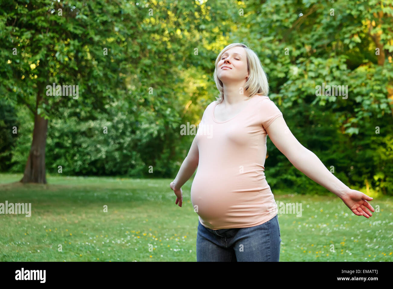 Pregnant woman in the park Stock Photo - Alamy