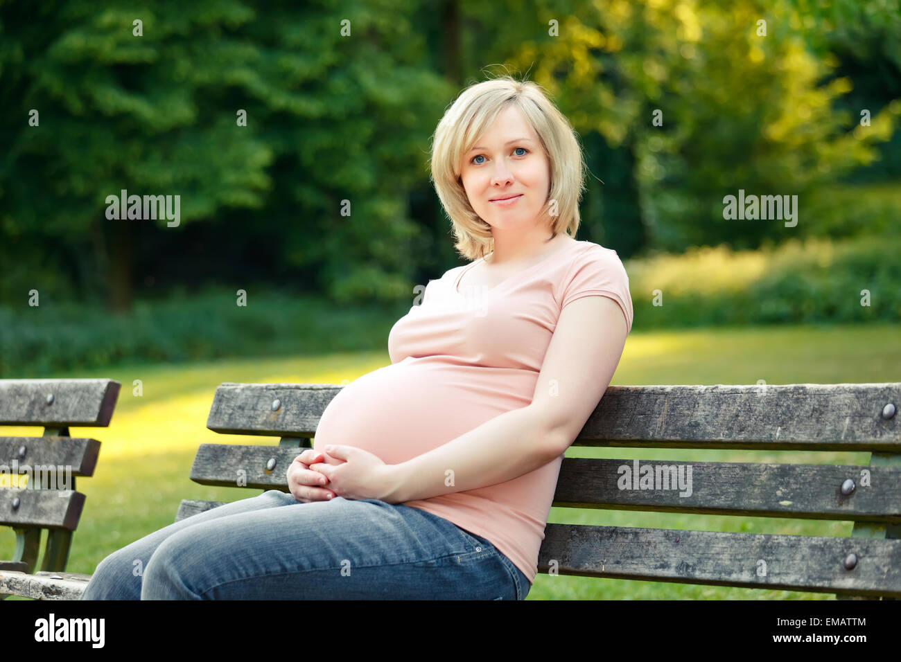 Pregnant woman in the park Stock Photo - Alamy