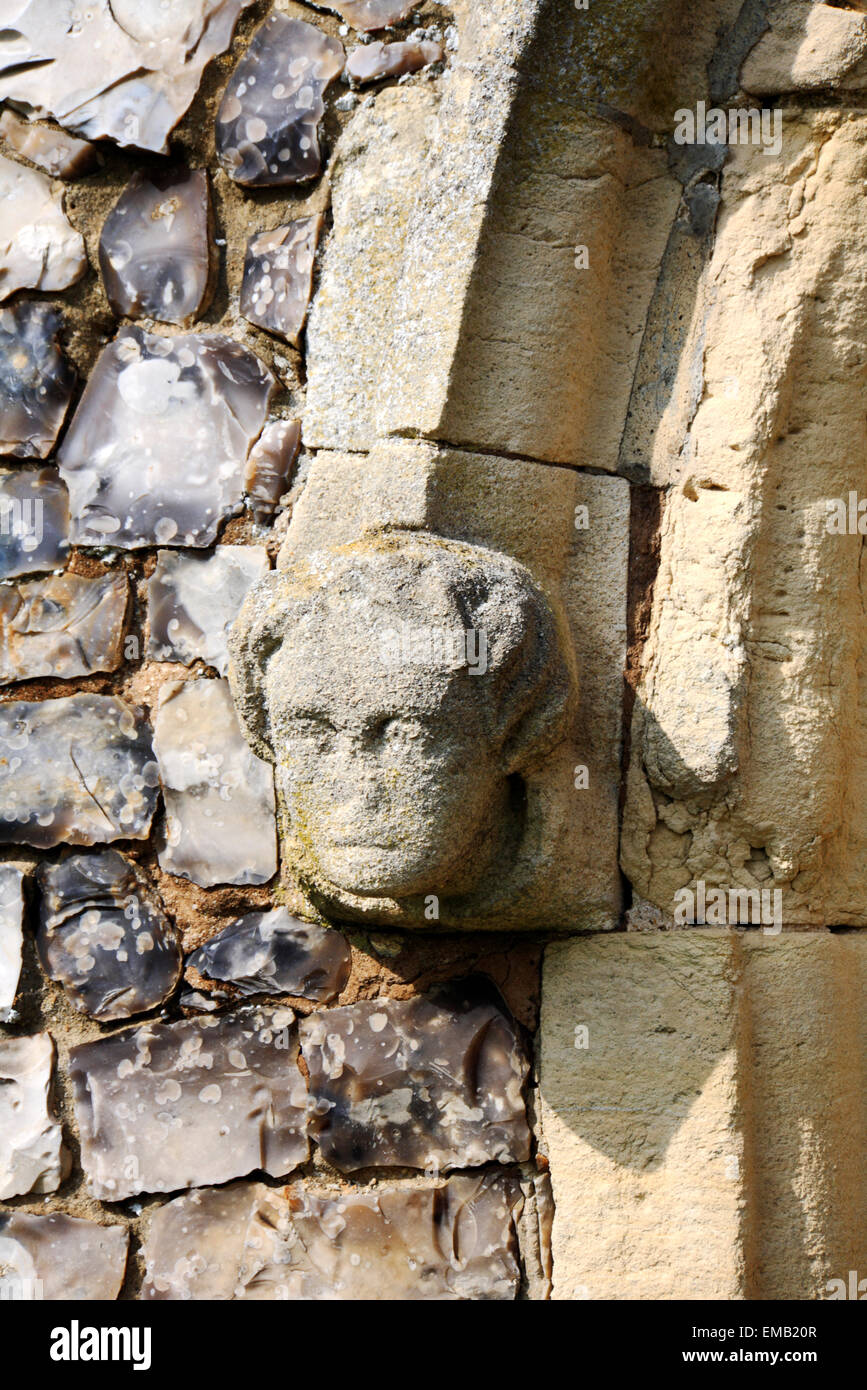 A carved stone head by the priests door at the parish church of St Catherine at Ludham, Norfolk, England, United Kingdom. Stock Photo