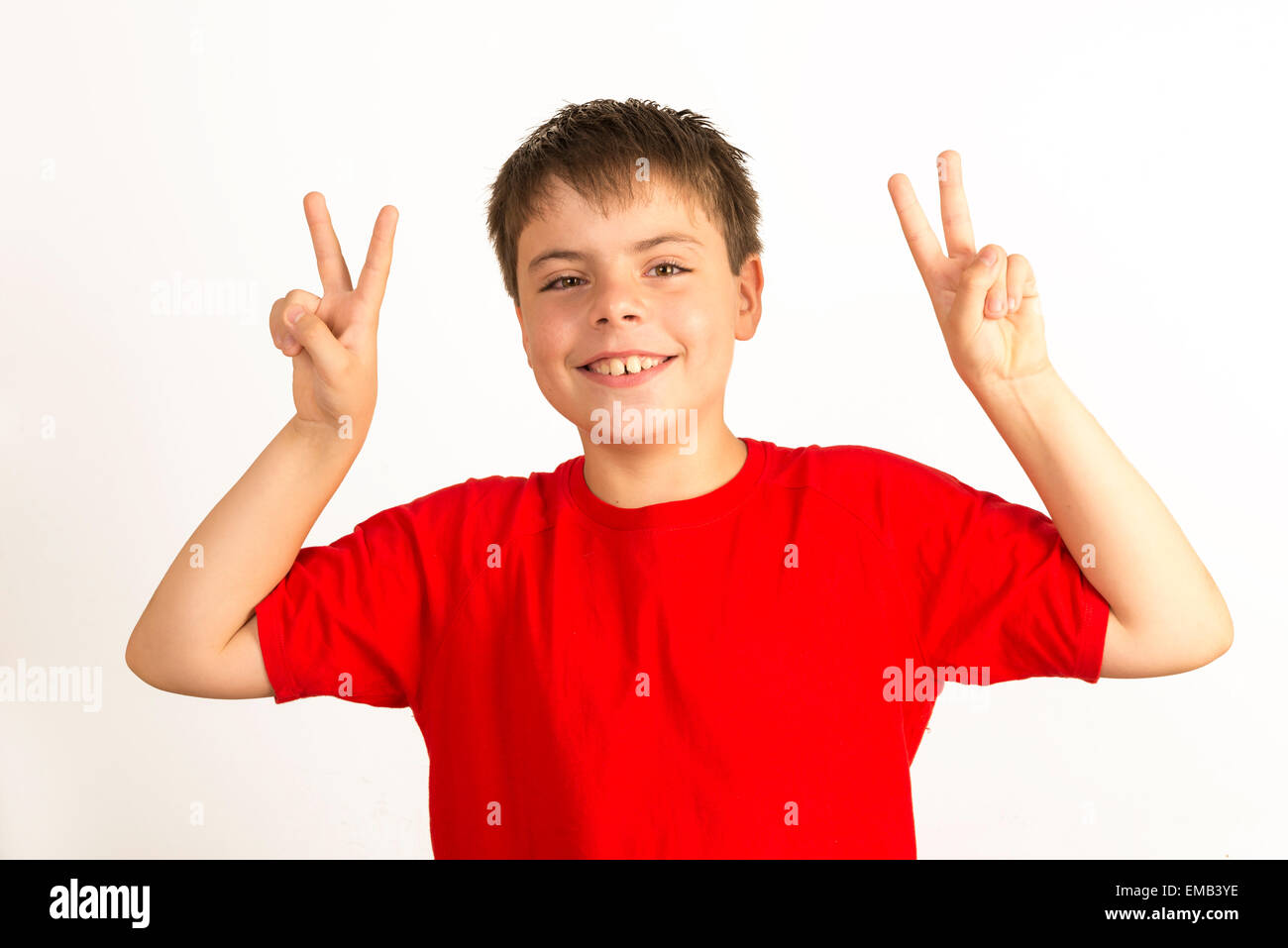 young boy with red shirt Making Peace Sign or victory Stock Photo Alamy