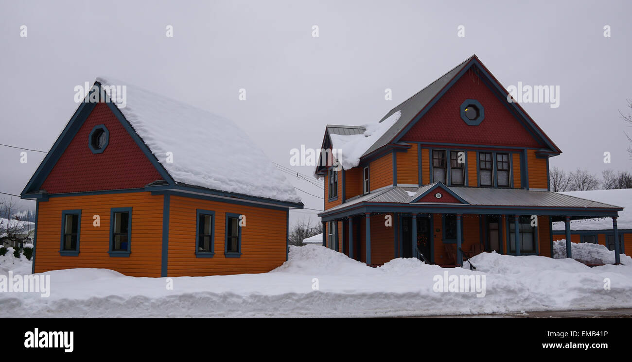 Colorful house covered in snow in the winter. Stock Photo
