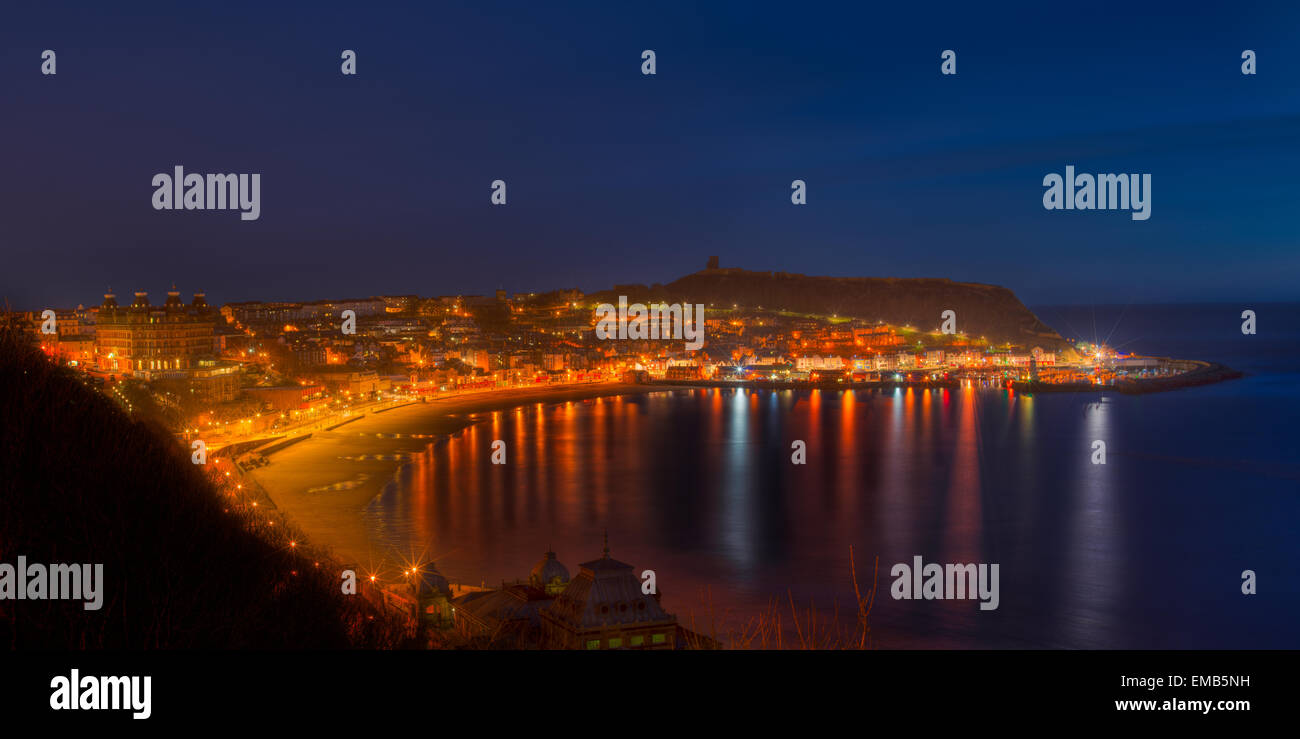 A colorful sunrise panoramic of Scarborough UK overlooking the beach, boardwalk and main part of town. Stock Photo